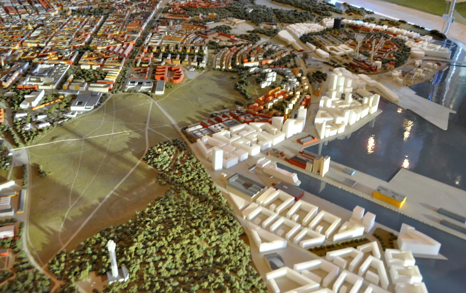 Architectural scale model of the Stockholm Royal Seaport (Norra Djurgardsstaden) masterplan, photographed at Kulturhuset in 2011, viewed from an oblique aerial angle: white new-build blocks of the pla