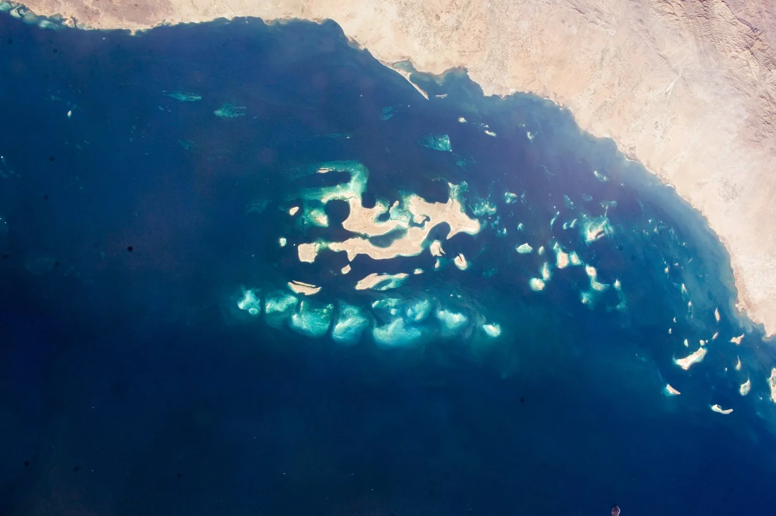 Satellite view of the Red Sea coast of Saudi Arabia, the setting of The Red Sea Project masterplan (representative alternative; the development is a greenfield resort scheme).