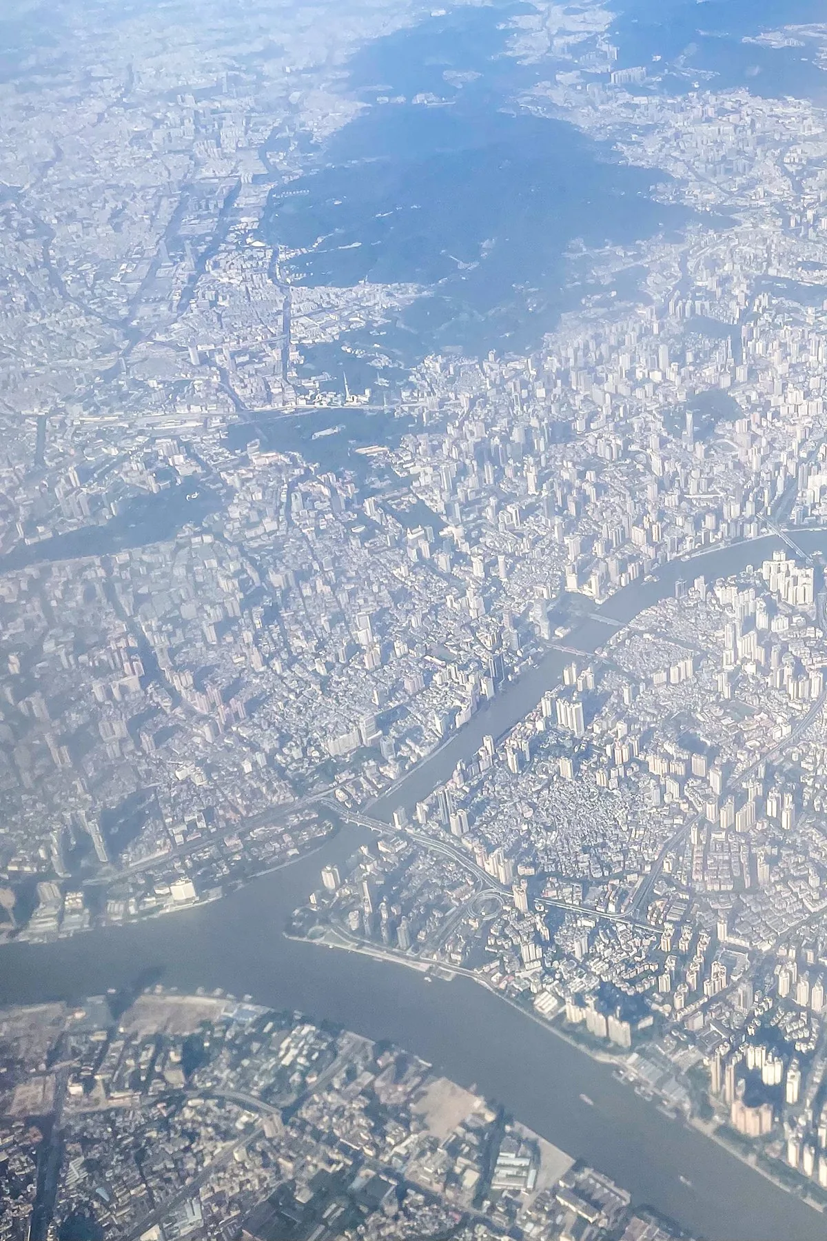 Aerial view of Guangzhou and the Pearl River (2020); the Bai'etan Financial District lies on the river in Liwan District.