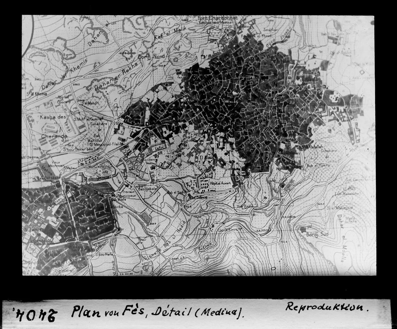 Early-20th-century street plan of the Fes el-Bali medina showing the dense organic fabric of alleys split by the Fez river into the Qarawiyyin and Andalusian quarters. (JPEG render of the source TIFF.