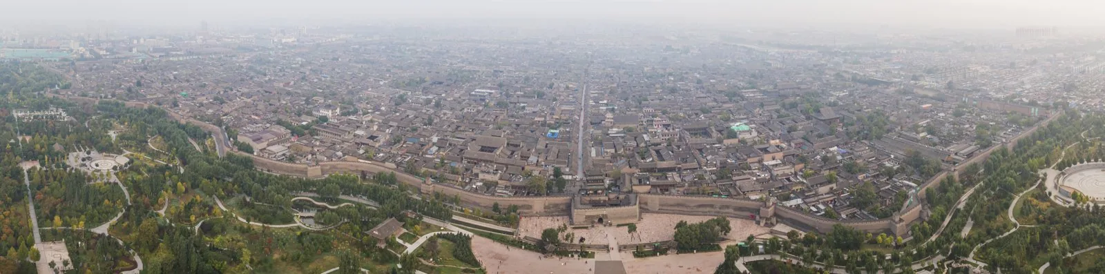 Aerial panorama of the walled Ming-dynasty city of Pingyao, in which the rectangular circuit of city walls and the regular grid of streets and courtyard blocks (the ba-gua-influenced plan) are clearly
