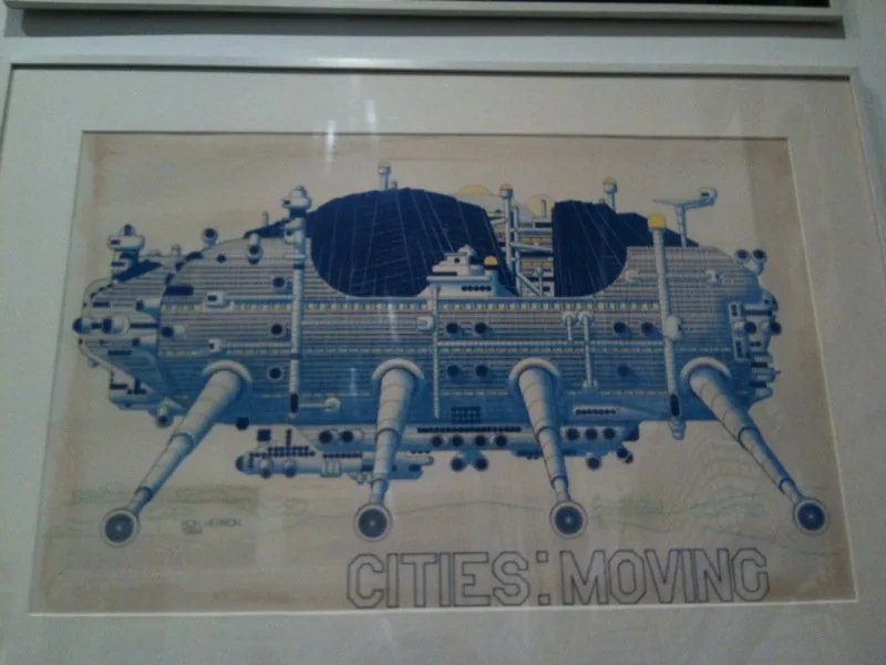 Verified: framed exhibition photo of Ron Herron's original signed 1964 Walking City drawing titled 'CITIES: MOVING' — the iconic insect-legged moving megastructure. Clearly shows the project's scheme/