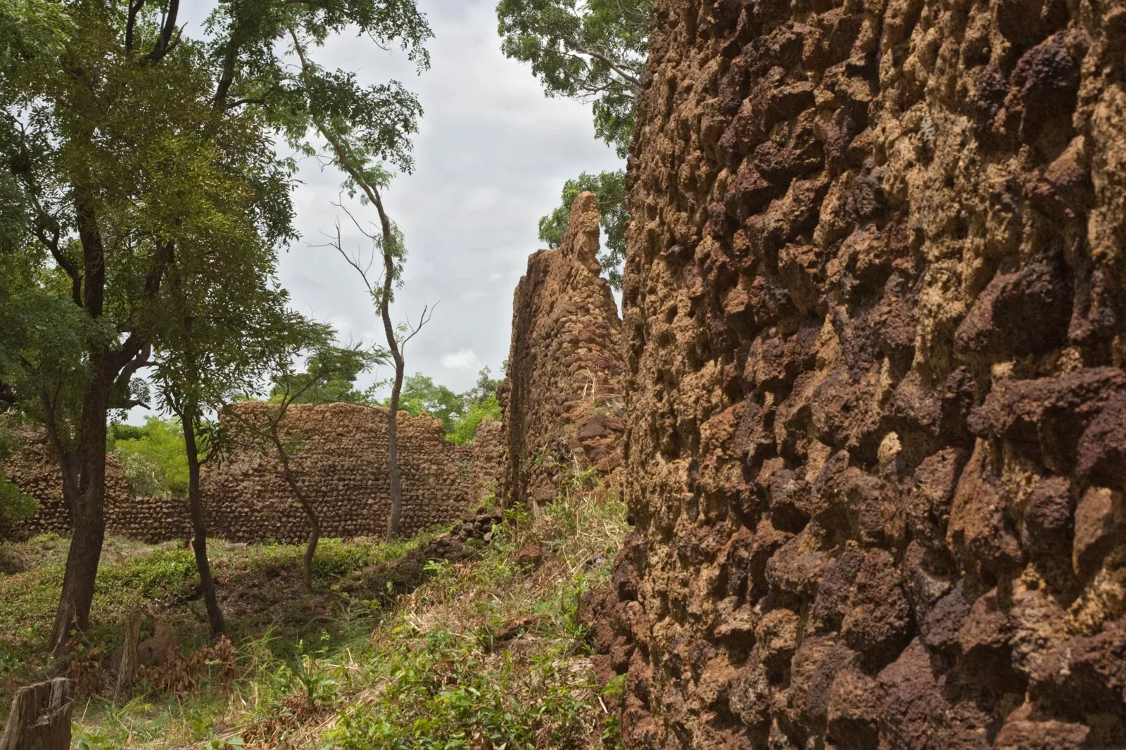 Surviving stone perimeter walls of the Ruins of Loropéni, the oldest fortified settlement in Burkina Faso.